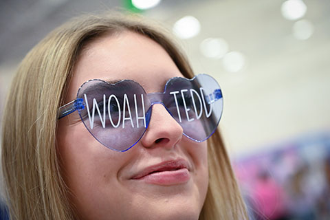 A female with sunglasses that read 