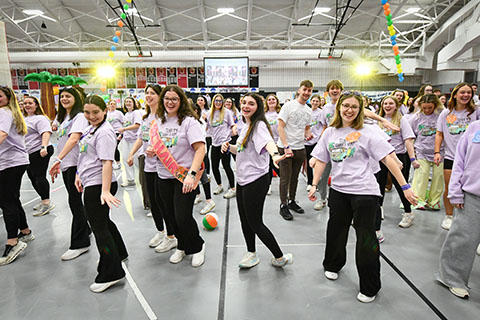 Teddi dancers in line learning the line dance and smiling