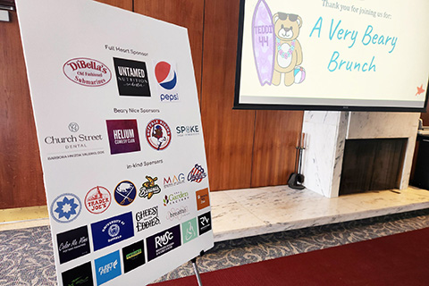 A sign with sponsors logos at the Very Beary Brunch.