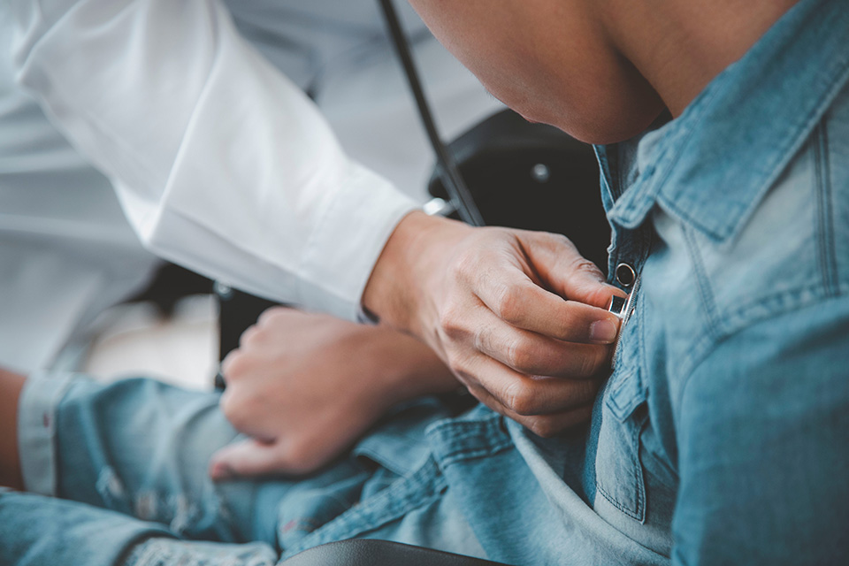 A healthcare provider uses a stethoscope to listen to a heart.