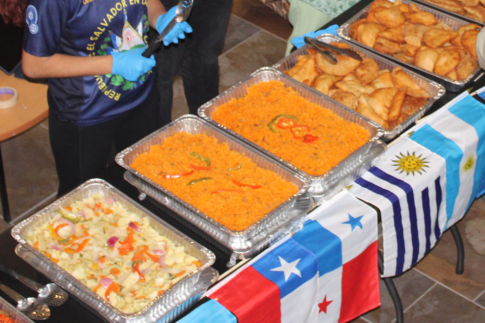 Sabor Latino event with a buffet of Latino food and flags.
