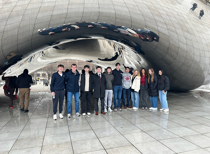 Students stand under the Bean in Chicago.