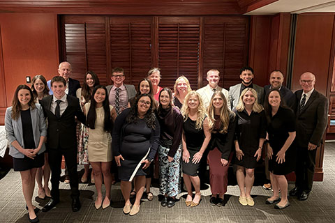 Students with President Rooney and alumni at an alumni reception