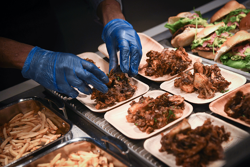 A chef plates food at Ward Haffey Dining Hall.