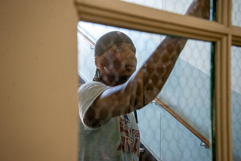 A football player spends time painting during the Cardinal Community Blitz.