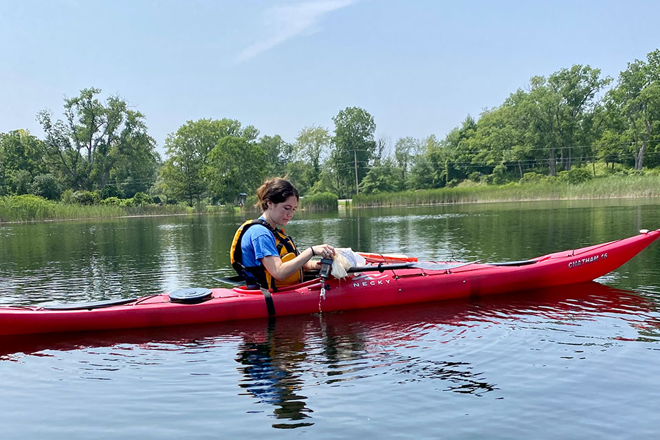 Allie Bruno collects samples from Mendon Ponds for a study about water fleas.