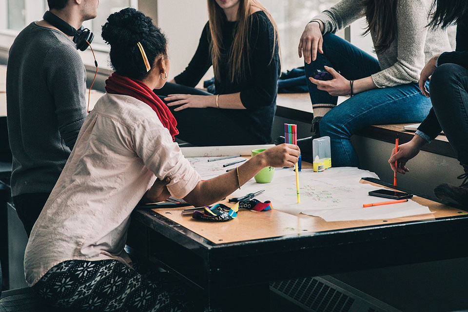 People sit around a table during a meeting.