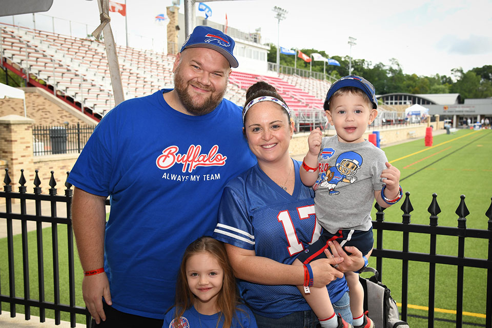 A Fisher alumnus with their family at the 2022 Bills Training Camp.