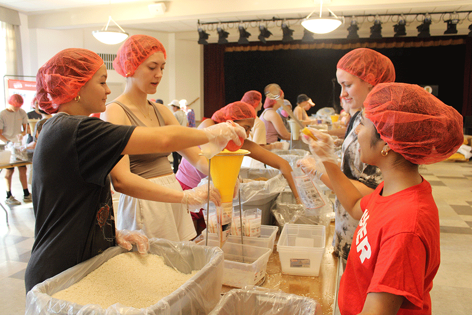 Students volunteer at the 2023 Rise Against Hunger service project.