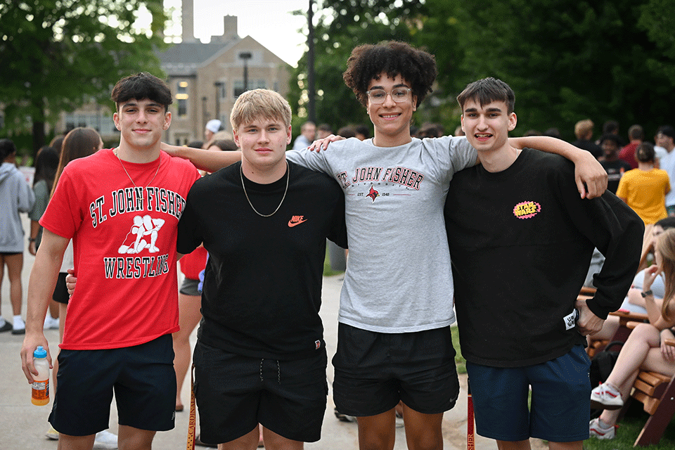 Four Fisher students smile together during Welcome Weekend 2023.