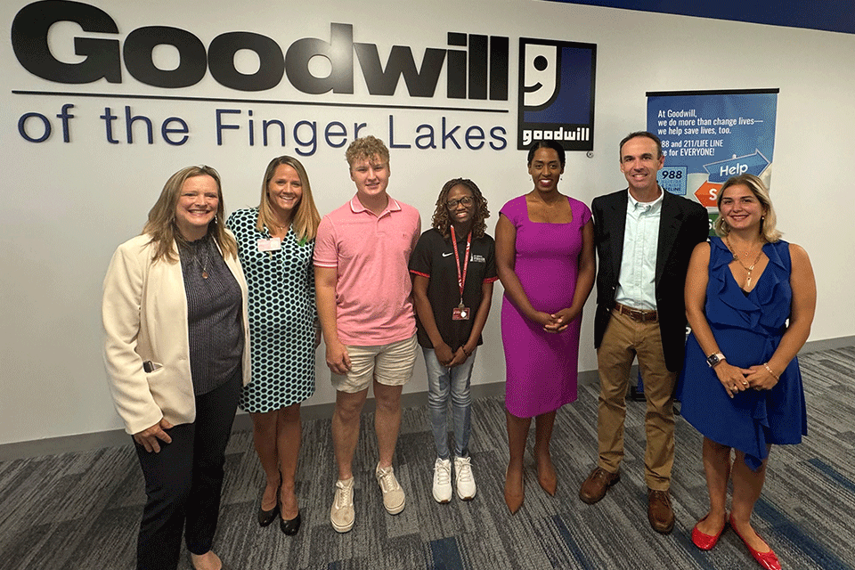 Rebecca Kieffer, along with several Fisher faculty members and students, attend a joint press conference held by NY public leaders at the Goodwill of Finger Lakes.