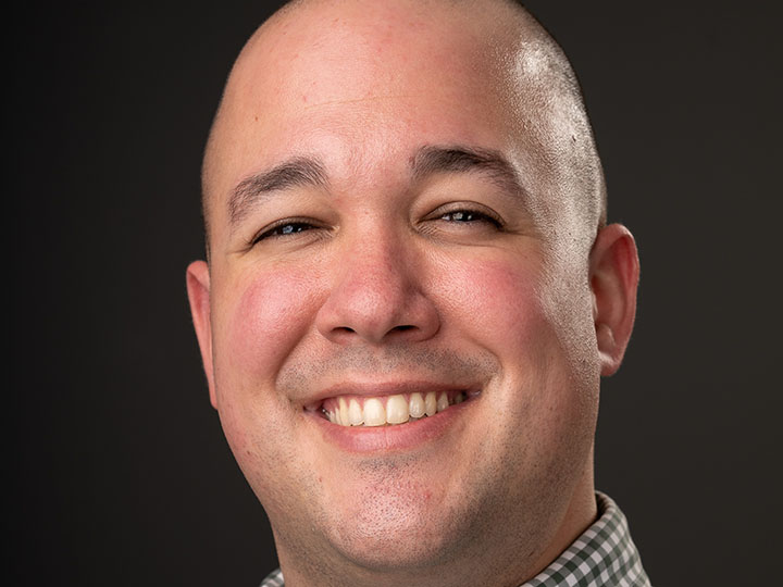 A headshot of Alex Hopkins Ives.