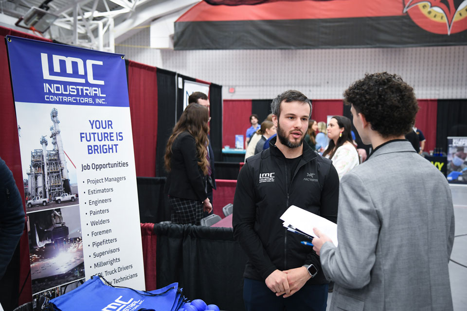 A student speaks with a potential employer at the Career Fair.