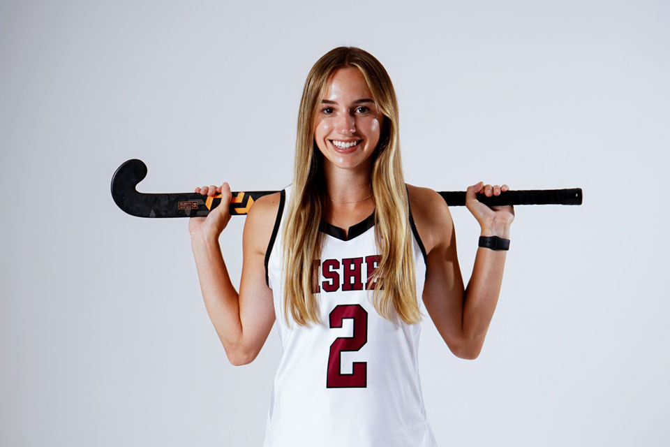 Emma Cooper holds her field hockey stick.