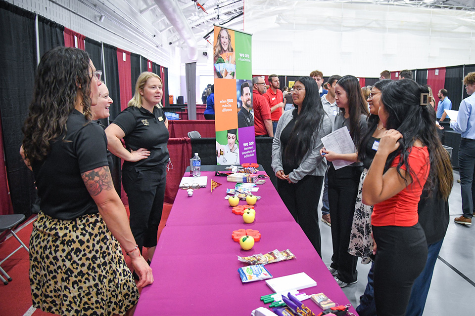 Group of students meeting with employers at the Career Fair.