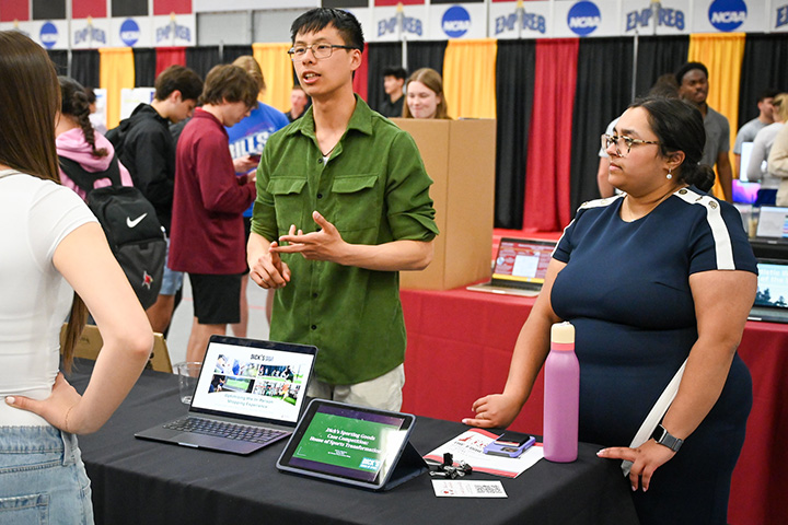 Students at the Fisher Showcase share a business class project.