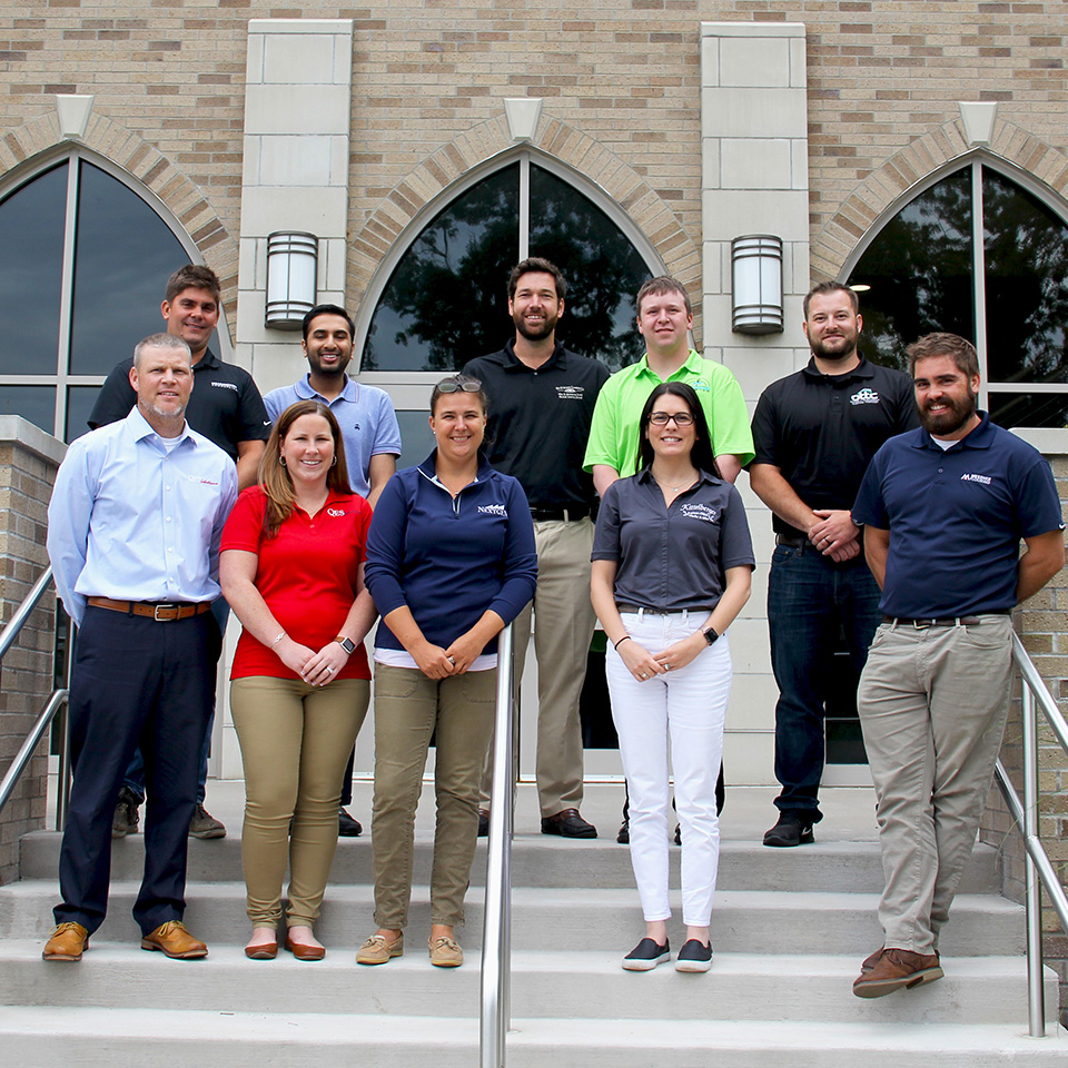 Members of the Next Generation Leadership Institute Cohort stand on the stairs at the School of Business at Fisher.