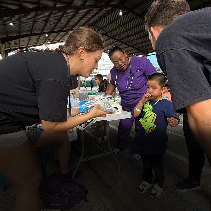 A Fisher pharmacy student offers instructions at a community clinic in Guatemala