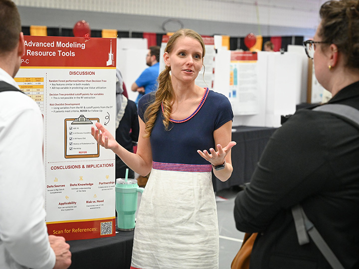 Student Explaining Poster at Research Symposium
