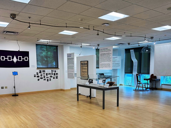 A wide photo of the 1924: Looking Back at the Last 100 Years of Hodinohso:ni Governance, Self-Determination, and Sovereignty exhibit at St. John Fisher University's Patricia O'Keefe Ross Gallery.