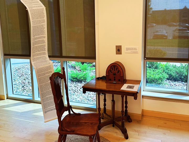 A printed speech is draped over a classic radio.