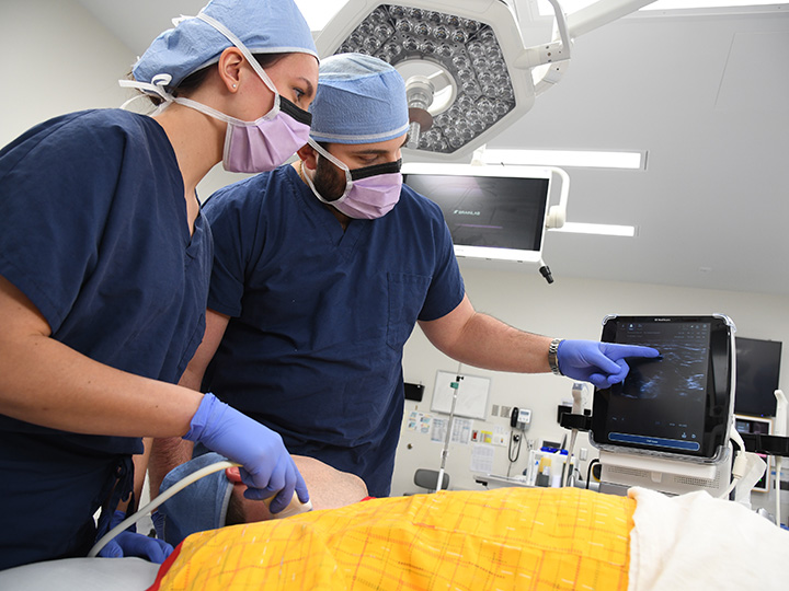 CRNAs monitoring anesthesia for a patient during a medical procedure