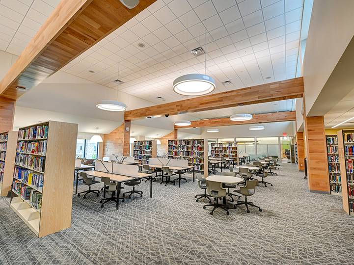Ample student workspaces among the book collection at Lavery Library.