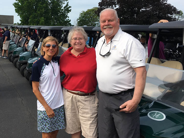 Three golfers standing together at the GDL Tournament