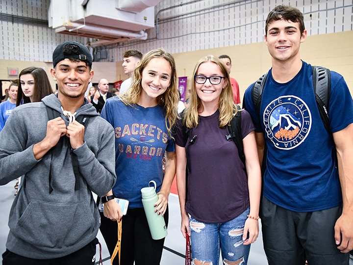 Four smiling first-year students at matriculation.