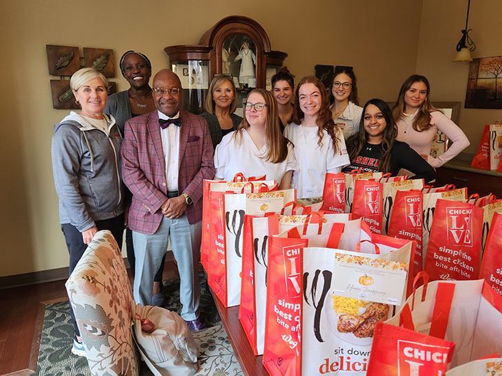 Students stand with bags packed for a community service project.