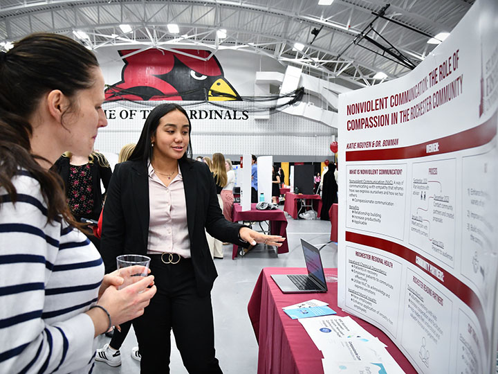 A student presents research at the Fisher Showcase.