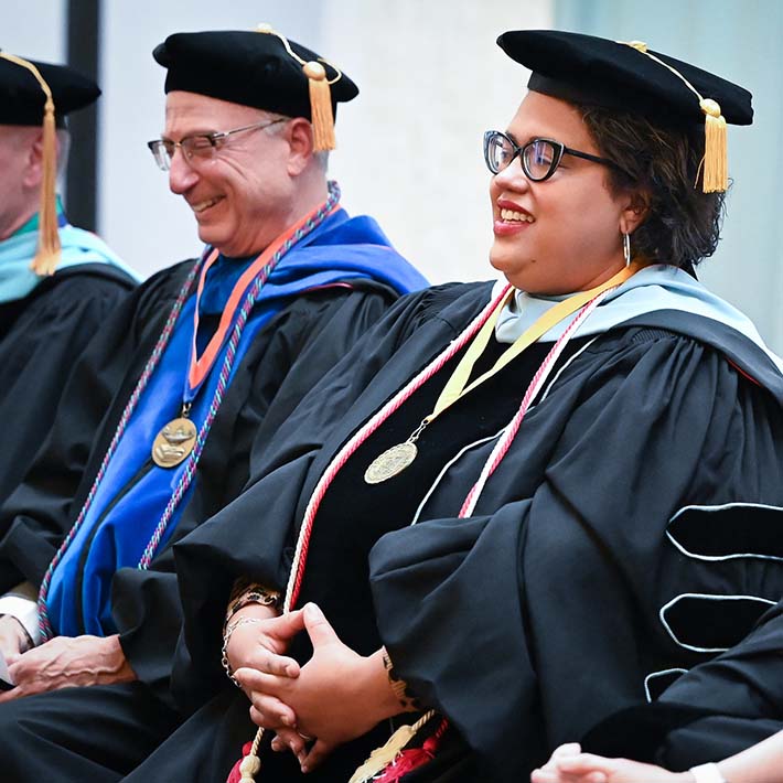 Ed.D. Faculty seated together in commencement regalia.