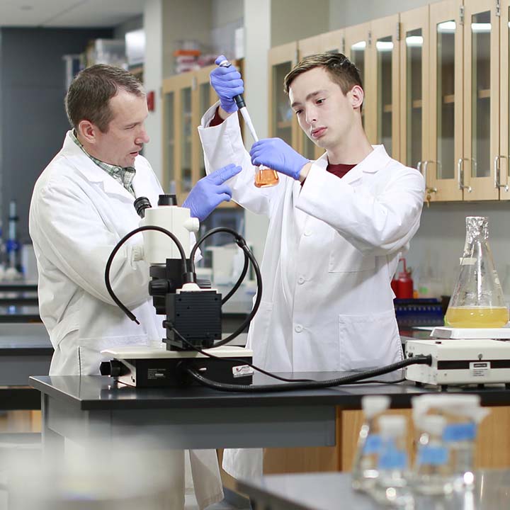 Professor and student in a science lab.