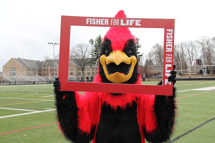 Beaks the Mascot holding a sign that says Fisher for Life.