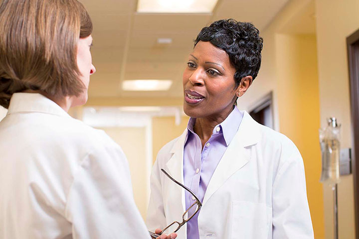 Healthcare Administration professionals discussing outcomes in a health setting.