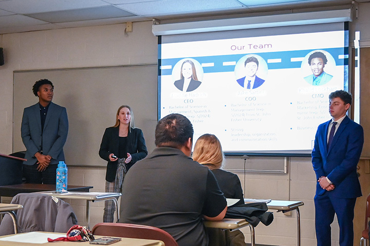 Students presenting in front of a class.
