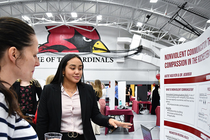 A student presents a Cardinal Capstone project at the Fisher Showcase.