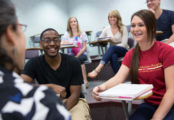 Students listening to professor in classroom