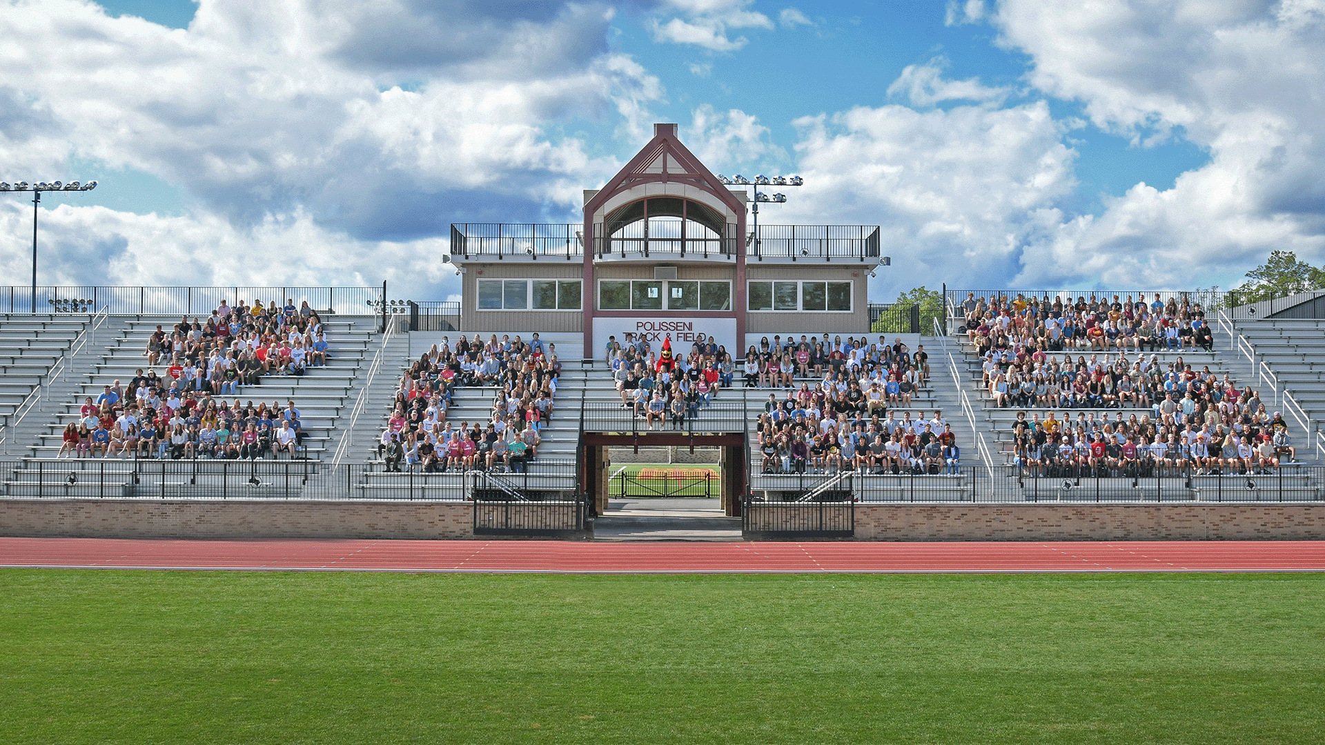 Incoming students seated on bleachers in formation of their graduating year 2025.