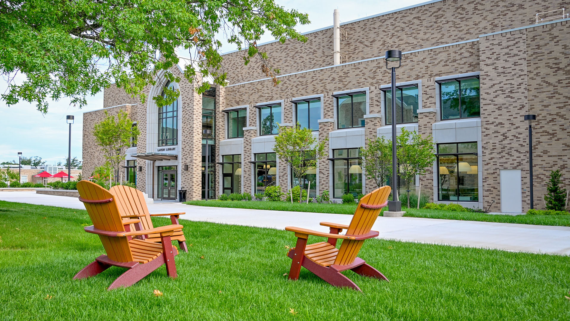 Adirondack chairs in front of Lavery Library during the summer.