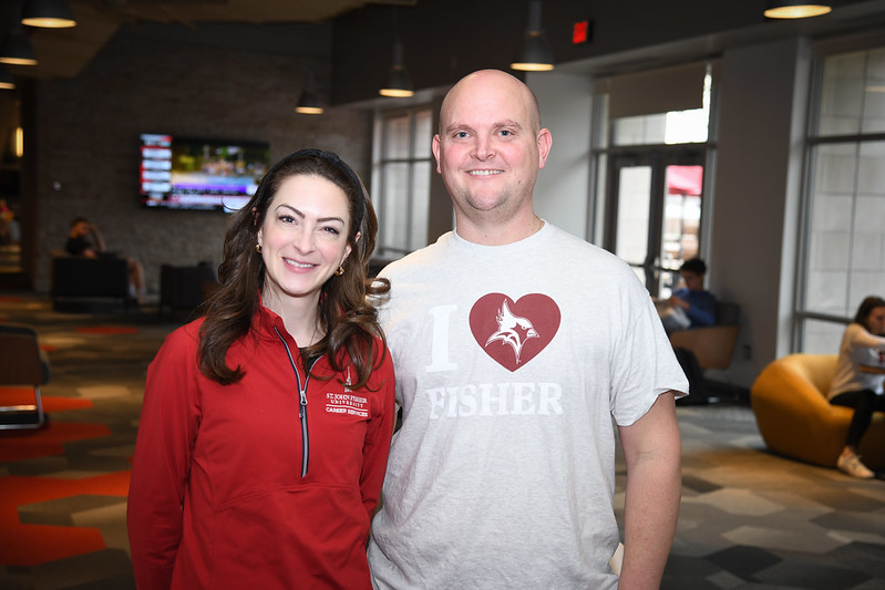 Alumnus and staff wearing shirts for I Heart Fisher Giving Day