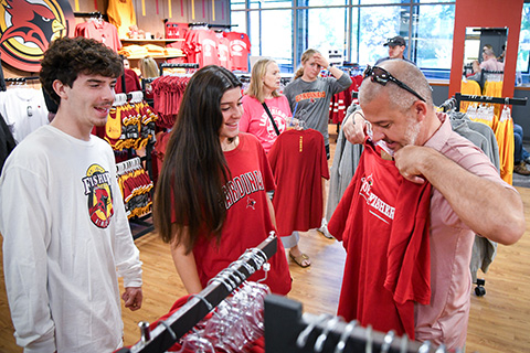 A family shops at the Cardinal Shop store on campus.