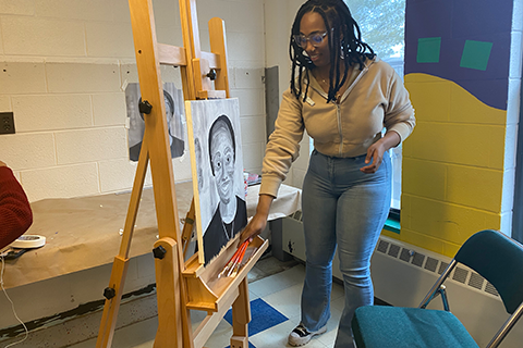 A student painting in the art studio