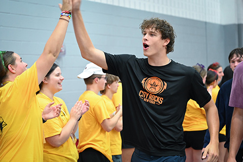 Students high-five during Welcome Weekend.