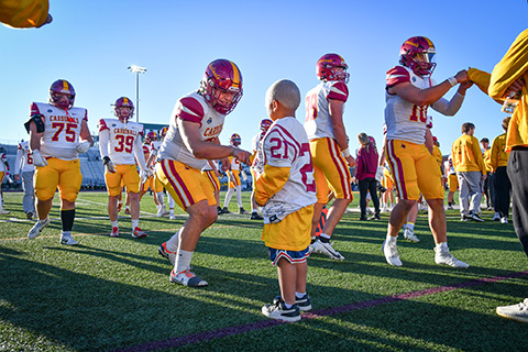 A player shakes hands with a Camp Good Days honorary coach.