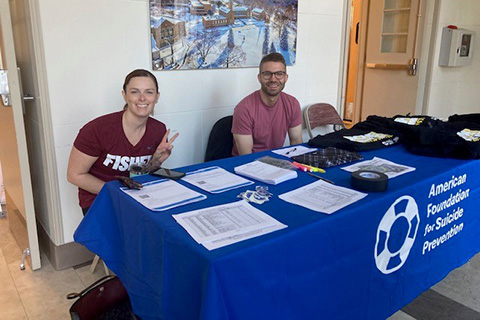 Volunteers at the registration table for the Out of the Darkness Walk for suicide prevention.