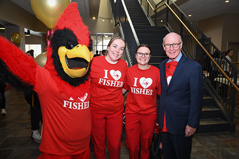 President Rooney stands with students in I Heart Fisher shirts.