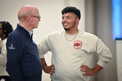 President Rooney talks with a student.