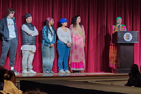 Students speak on stage during the Spirit of Identity Week.