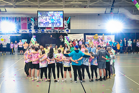 Students link arms at the Teddi Dance for Love